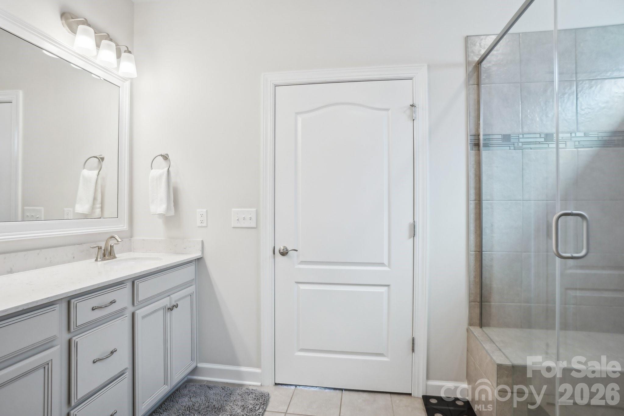 16427 Cozy Cove Road Charlotte, NC 28278 - Photo 16 of 47 a bathroom with a double vanity sink a mirror and shower