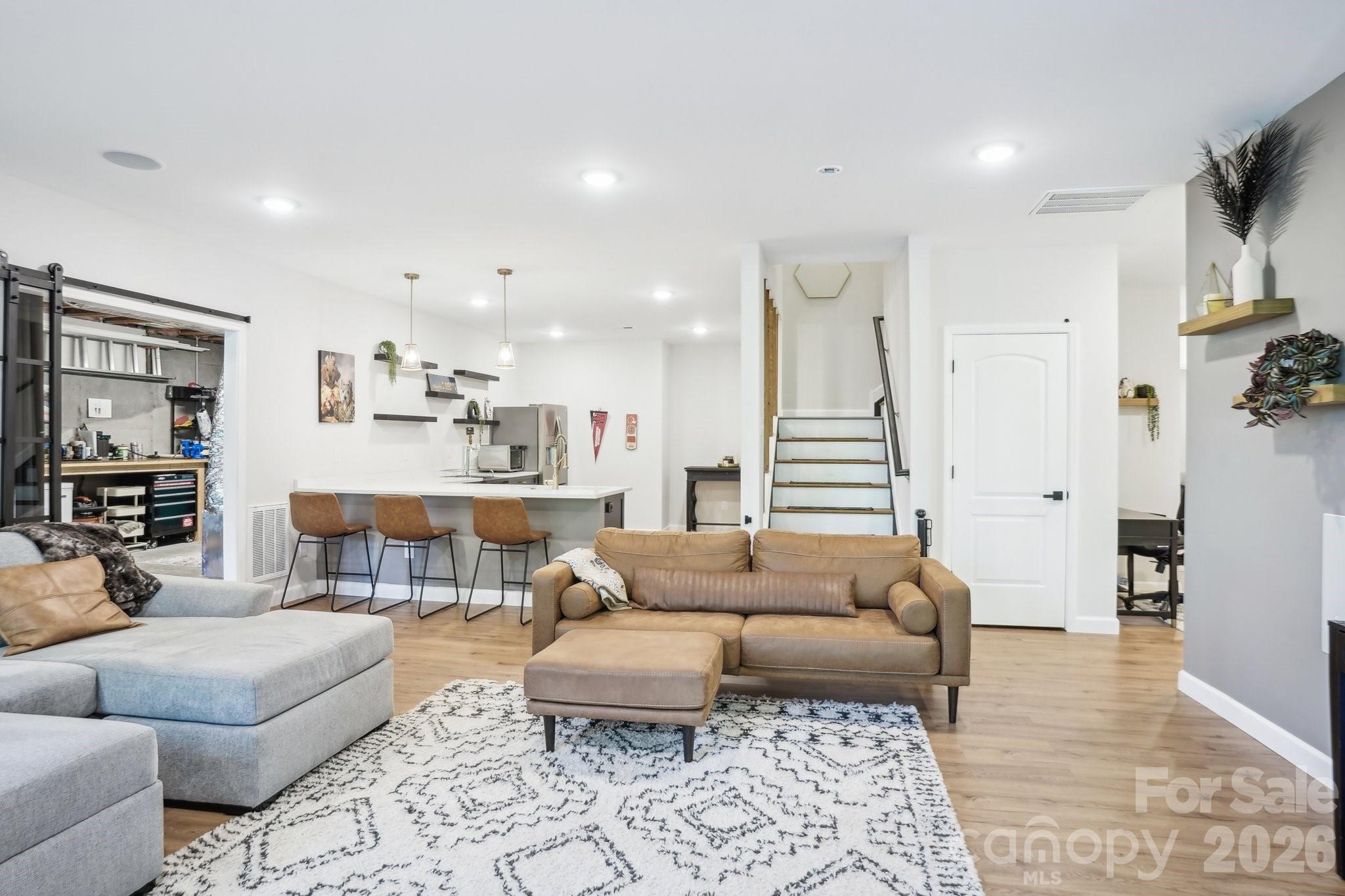 16427 Cozy Cove Road Charlotte, NC 28278 - Photo 22 of 47 a living room with furniture and a rug