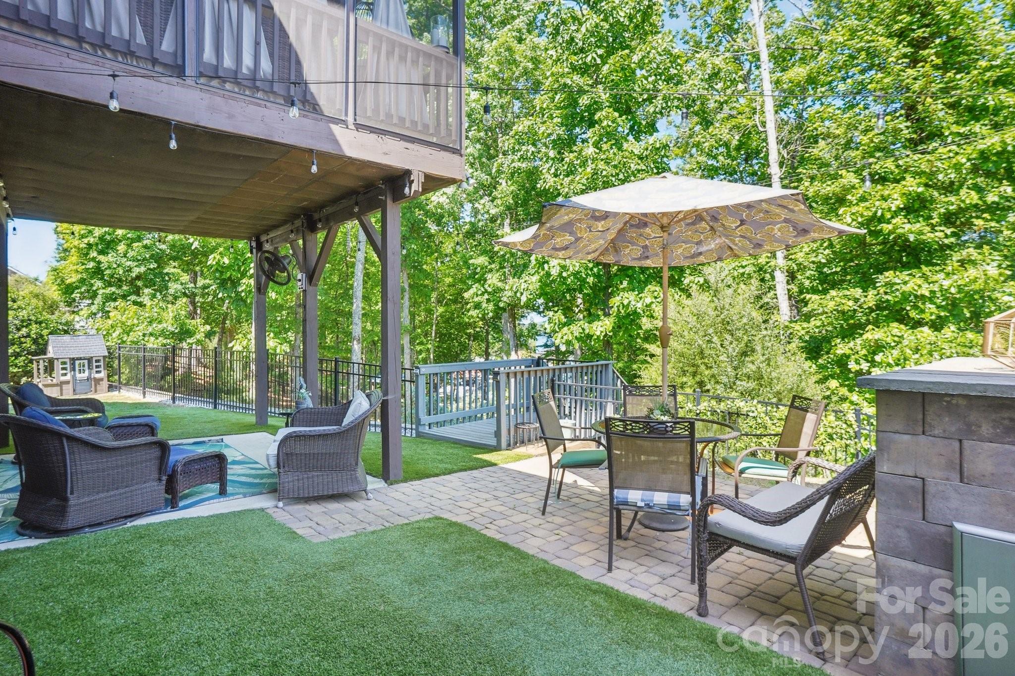 16427 Cozy Cove Road Charlotte, NC 28278 - Photo 37 of 47 a view of a chair and table under an umbrella