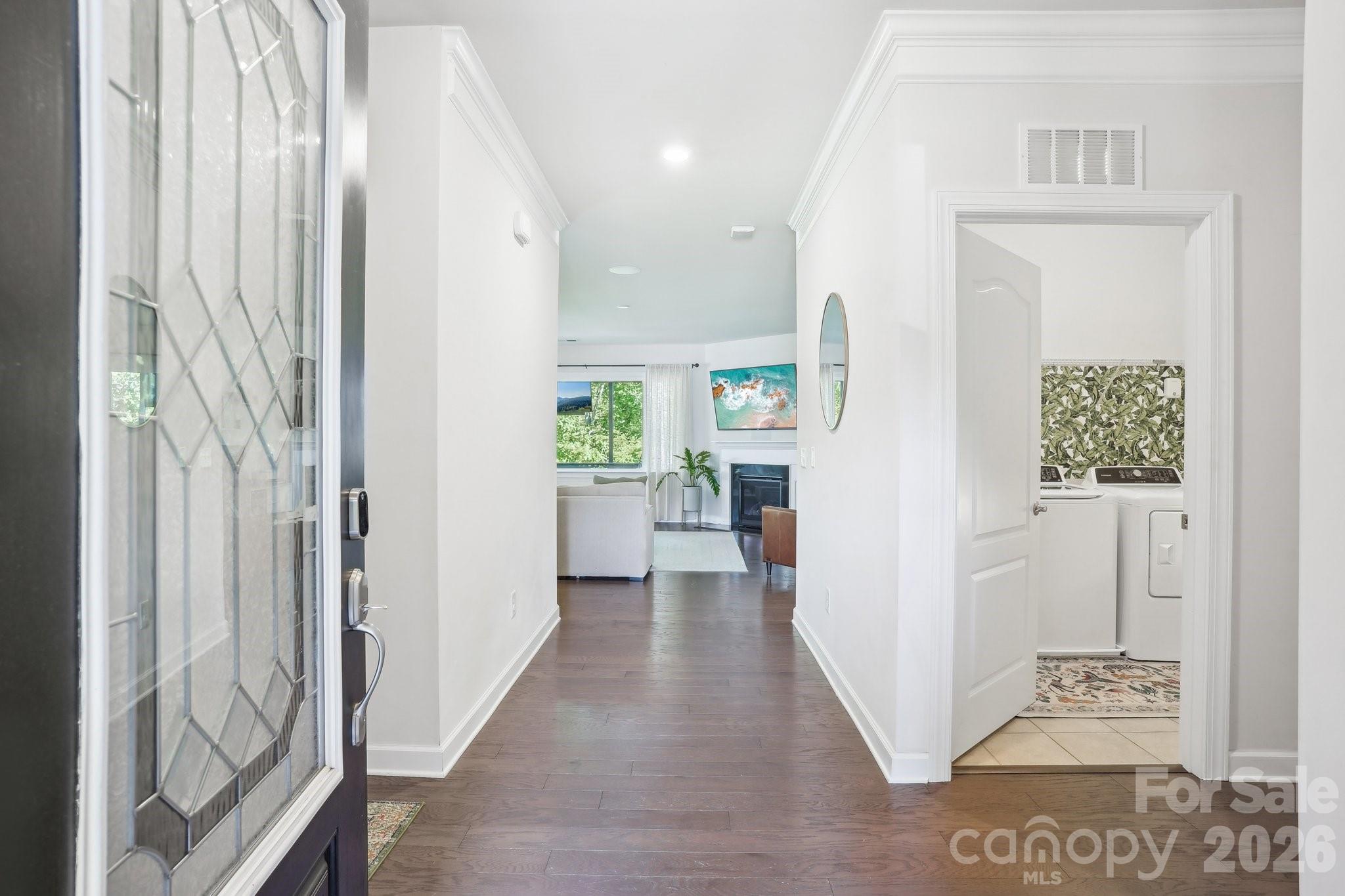 16427 Cozy Cove Road Charlotte, NC 28278 - Photo 6 of 47 a view of a hallway with wooden floor and a living room