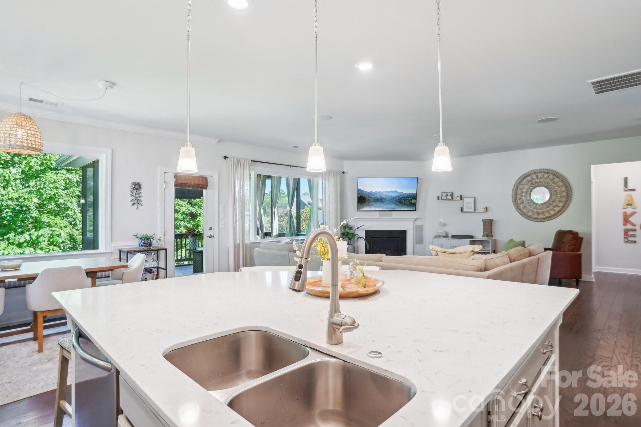 16427 Cozy Cove Road Charlotte, NC 28278 - Photo 10 of 47 a large kitchen with kitchen island a large counter space a sink appliances and a large window