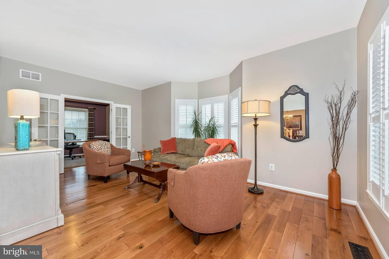 Living Room w Wood Floors and Plantation Shutters