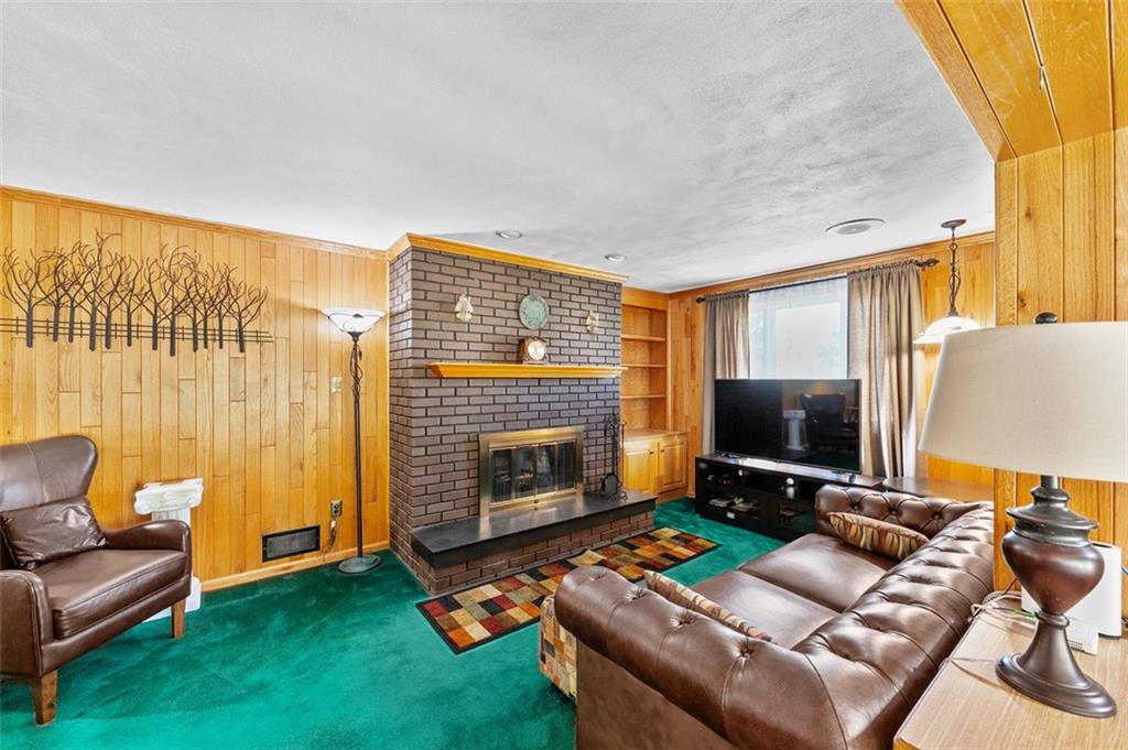 5920 Lee Street Export, PA 15632 - Photo 18 of 43 a living room with furniture a flat screen tv and a fireplace