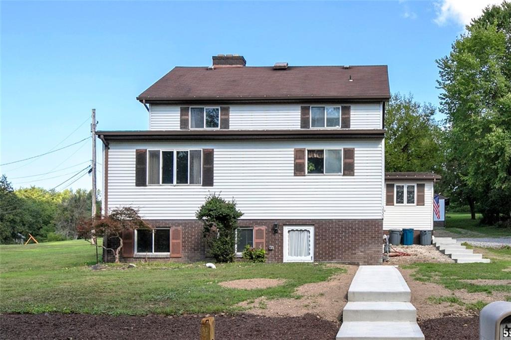 5920 Lee Street Export, PA 15632 - Photo 2 of 43 a front view of a house with a garden and yard