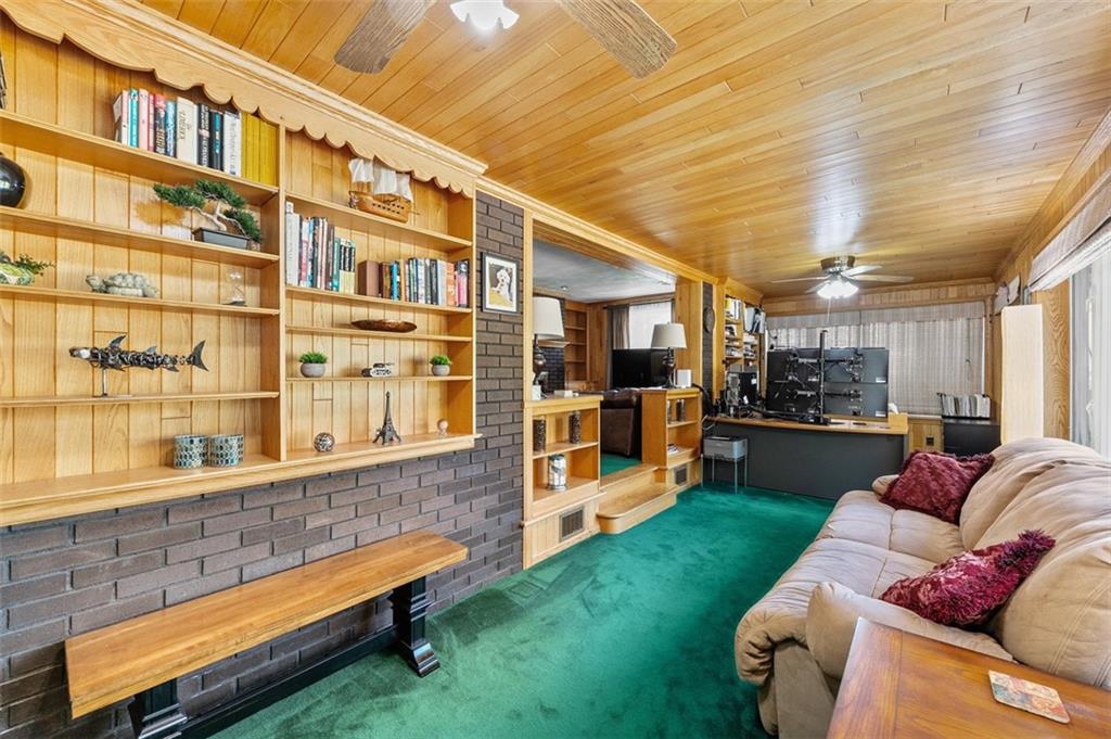 5920 Lee Street Export, PA 15632 - Photo 21 of 43 a living room with furniture a rug and a bookshelf