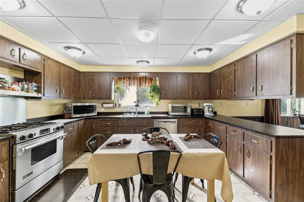 5920 Lee Street Export, PA 15632 - Photo 26 of 43 a kitchen with stainless steel appliances granite countertop a stove top oven a sink dishwasher and white cabinets with wooden floor
