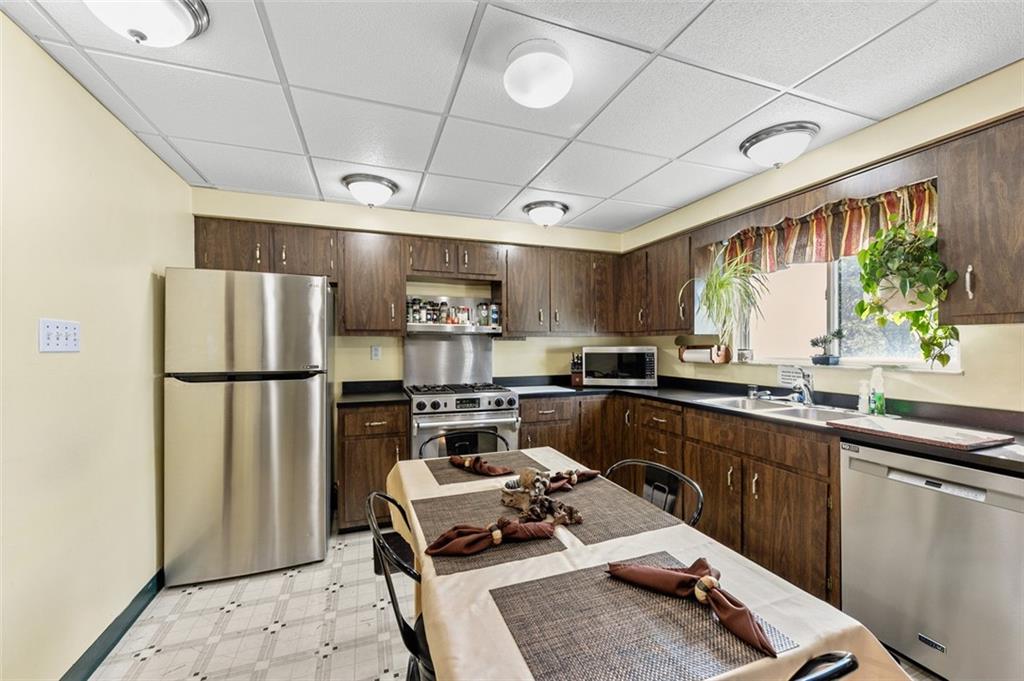 5920 Lee Street Export, PA 15632 - Photo 27 of 43 a kitchen with stainless steel appliances a refrigerator a sink a stove a table and chairs