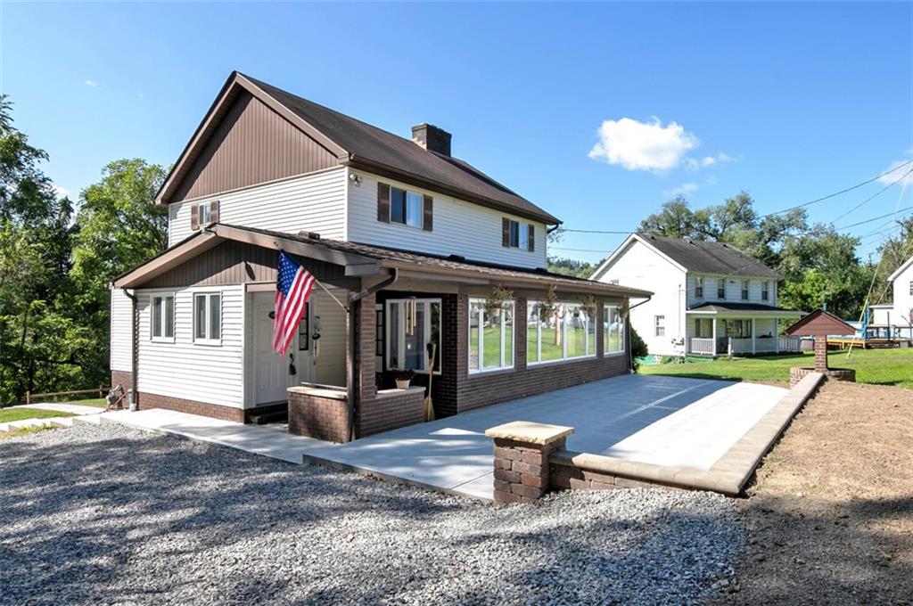 5920 Lee Street Export, PA 15632 - Photo 3 of 43 a front view of a house with a yard and potted plants