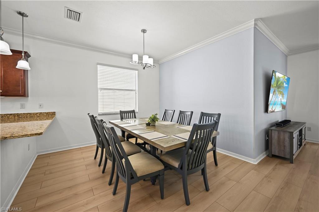 17549 Timberline Parkway Babcock Ranch, FL 33982 - Photo 11 of 39 a view of a dining room with furniture and wooden floor