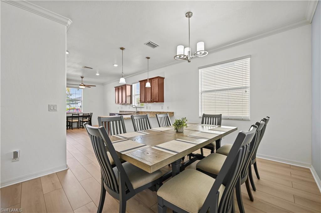 17549 Timberline Parkway Babcock Ranch, FL 33982 - Photo 12 of 39 a view of a dining room with furniture window and wooden floor