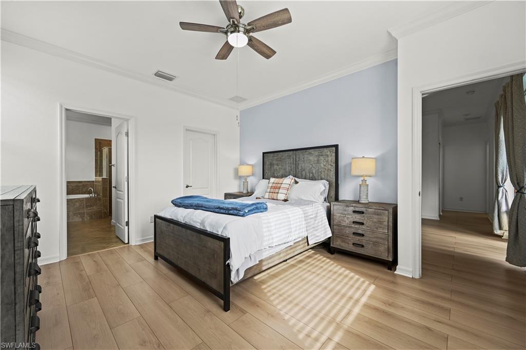 17549 Timberline Parkway Babcock Ranch, FL 33982 - Photo 15 of 39 a bed room with a bed and a chandelier