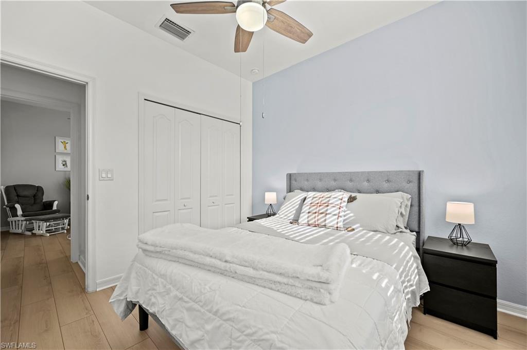 17549 Timberline Parkway Babcock Ranch, FL 33982 - Photo 19 of 39 a bedroom with a bed and a chandelier
