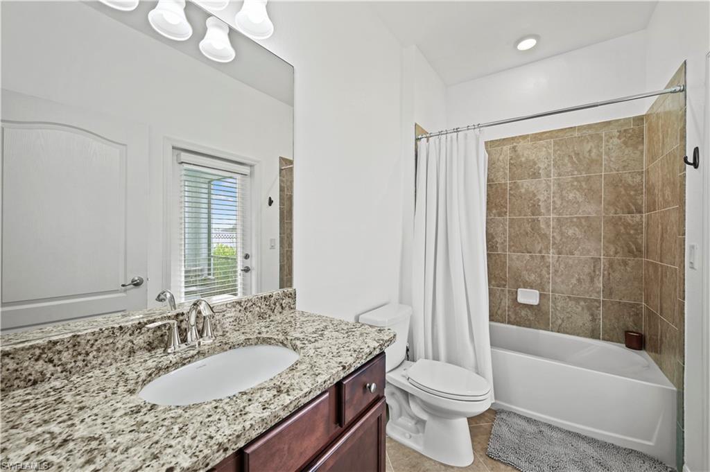 17549 Timberline Parkway Babcock Ranch, FL 33982 - Photo 21 of 39 a bathroom with a granite countertop sink toilet and shower
