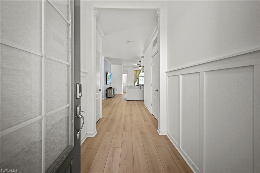 17549 Timberline Parkway Babcock Ranch, FL 33982 - Photo 22 of 39 a view of a hallway with wooden floor and staircase