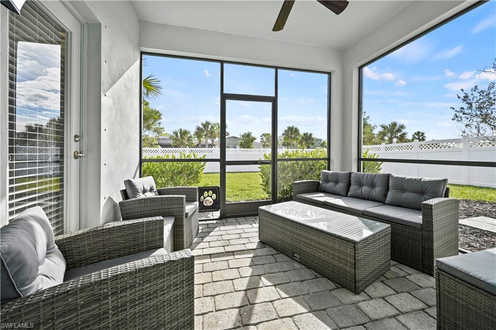 17549 Timberline Parkway Babcock Ranch, FL 33982 - Photo 24 of 39 a living room with furniture and a floor to ceiling window