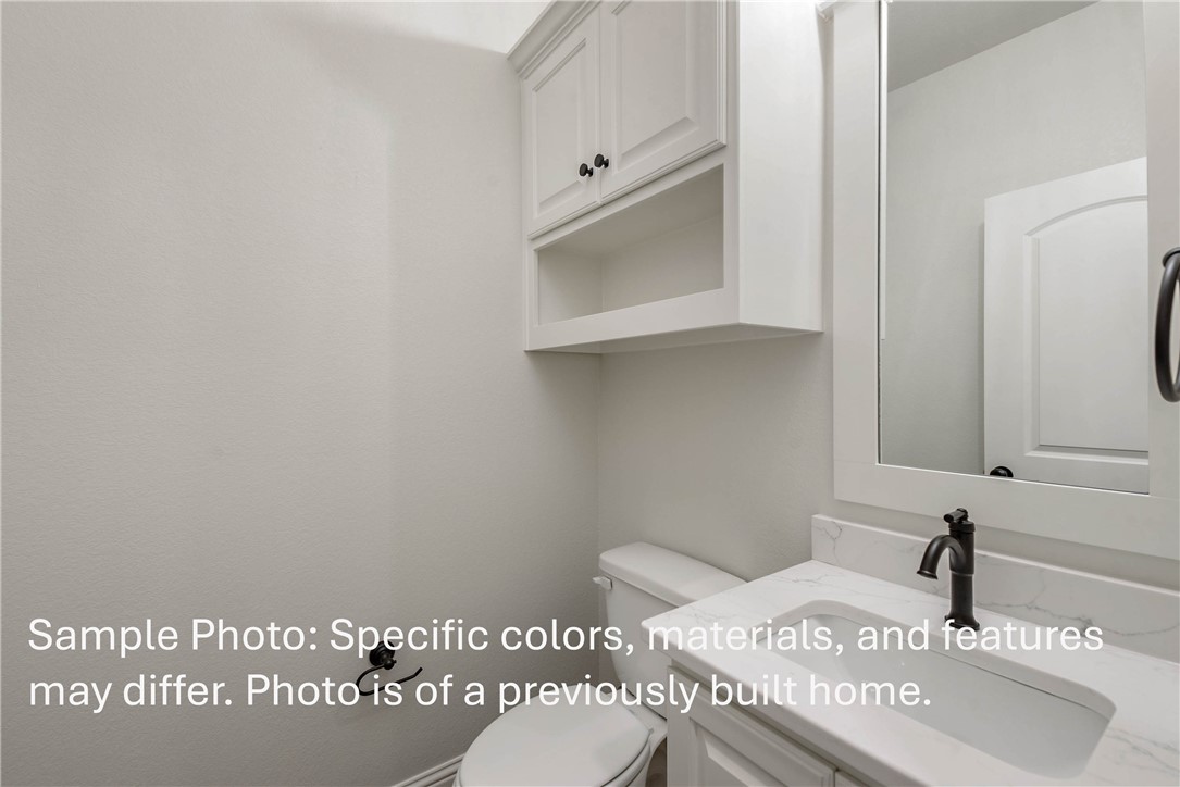 4027 Pacific Crest Way Bryan, TX 77802 - Photo 8 of 23 a bathroom with a sink a toilet and mirror