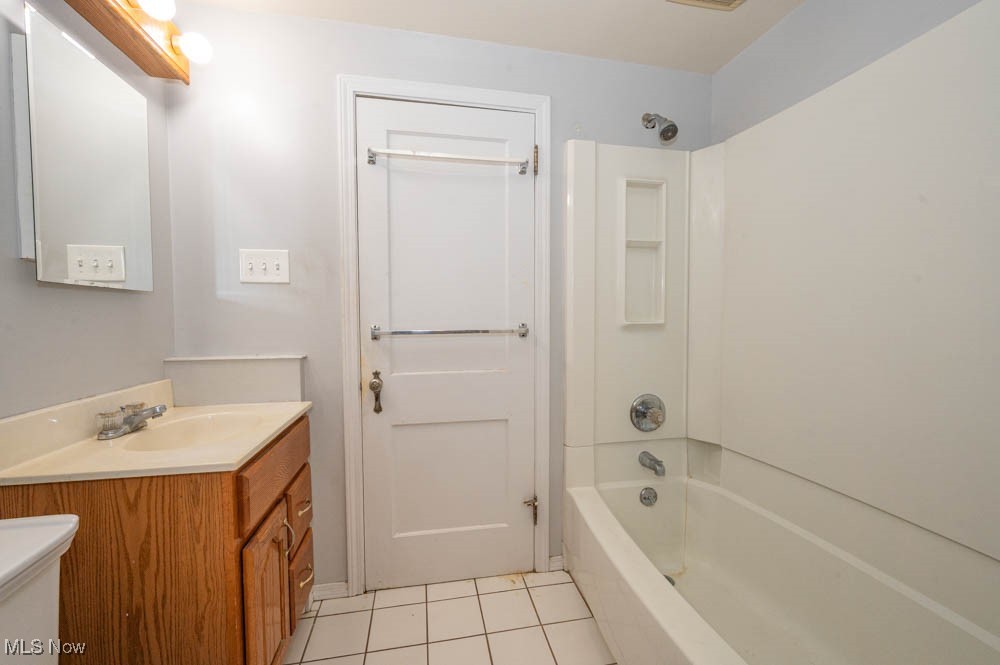 272 Ewing Road Youngstown, OH 44512 - Photo 17 of 19 Bathroom featuring shower / bath combination, light tile patterned floors, and vanity