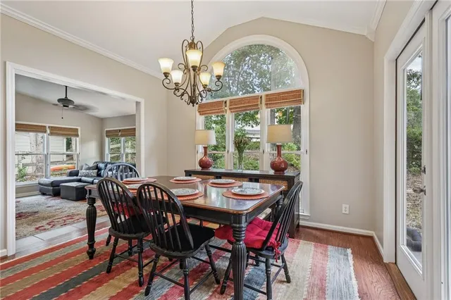 a view of a dining room with furniture wooden floor and chandelier