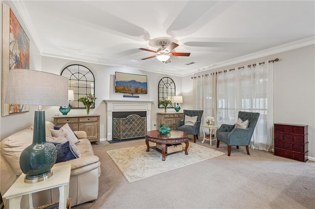 3820 Ridge Point Drive Suwanee, GA 30024 - Photo 7 of 41 a living room with furniture and a fireplace