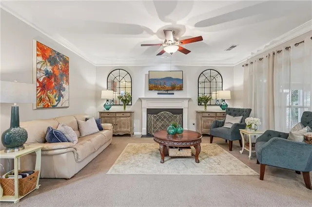 a living room with furniture fireplace and a large window