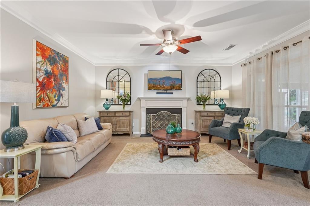 3820 Ridge Point Drive Suwanee, GA 30024 - Photo 9 of 41 a living room with furniture fireplace and a large window