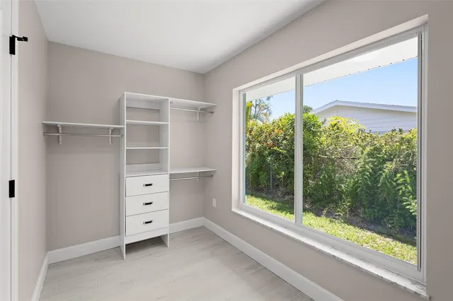 a view of room with window and cabinet