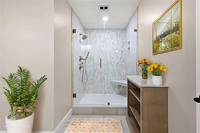 a bathroom with a tub shower and a sink