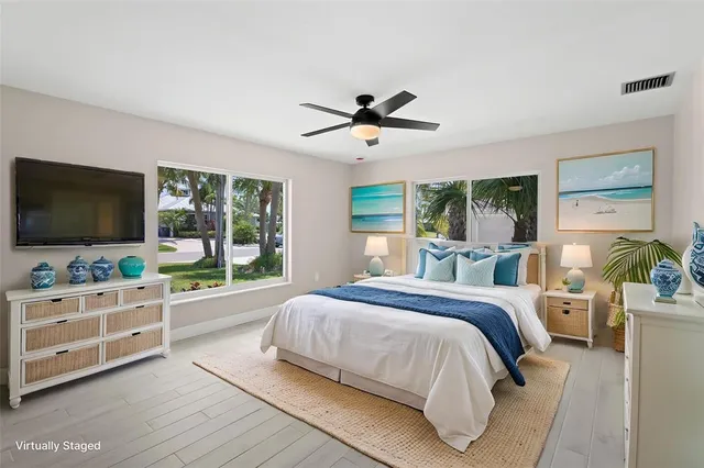 a bedroom with a large bed and a flat screen tv