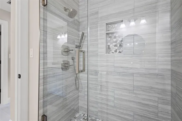a bathroom with a glass shower door