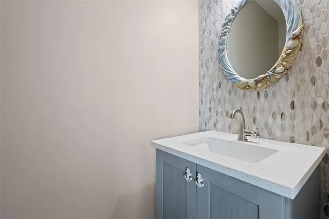a bathroom with a sink and mirror