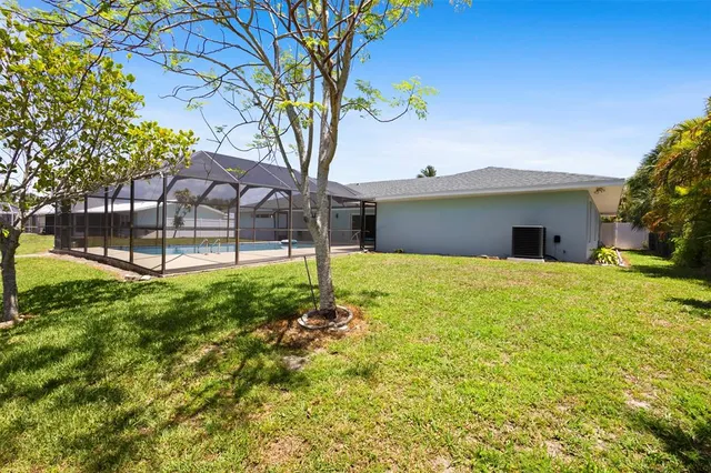 an aerial view of residential house with outdoor space and swimming pool