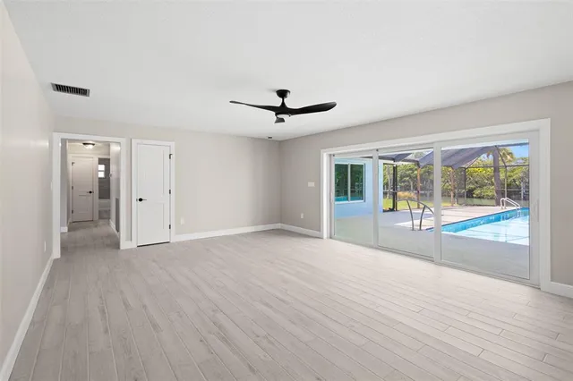 a view of empty room with wooden floor