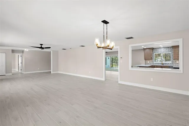 an empty room with fan and a ceiling fan