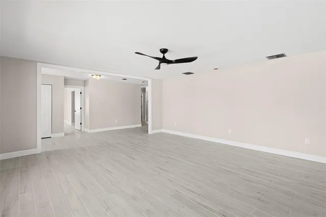 a view of an empty room with a ceiling fan
