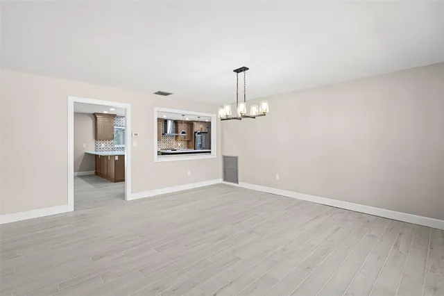 a view of an house with backyard and tree