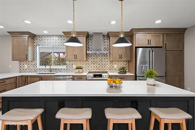 a kitchen with a sink a refrigerator and chairs