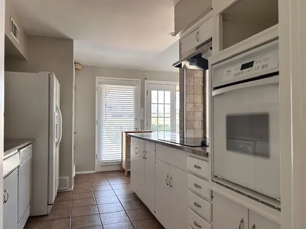 a kitchen with stainless steel appliances a refrigerator and a stove