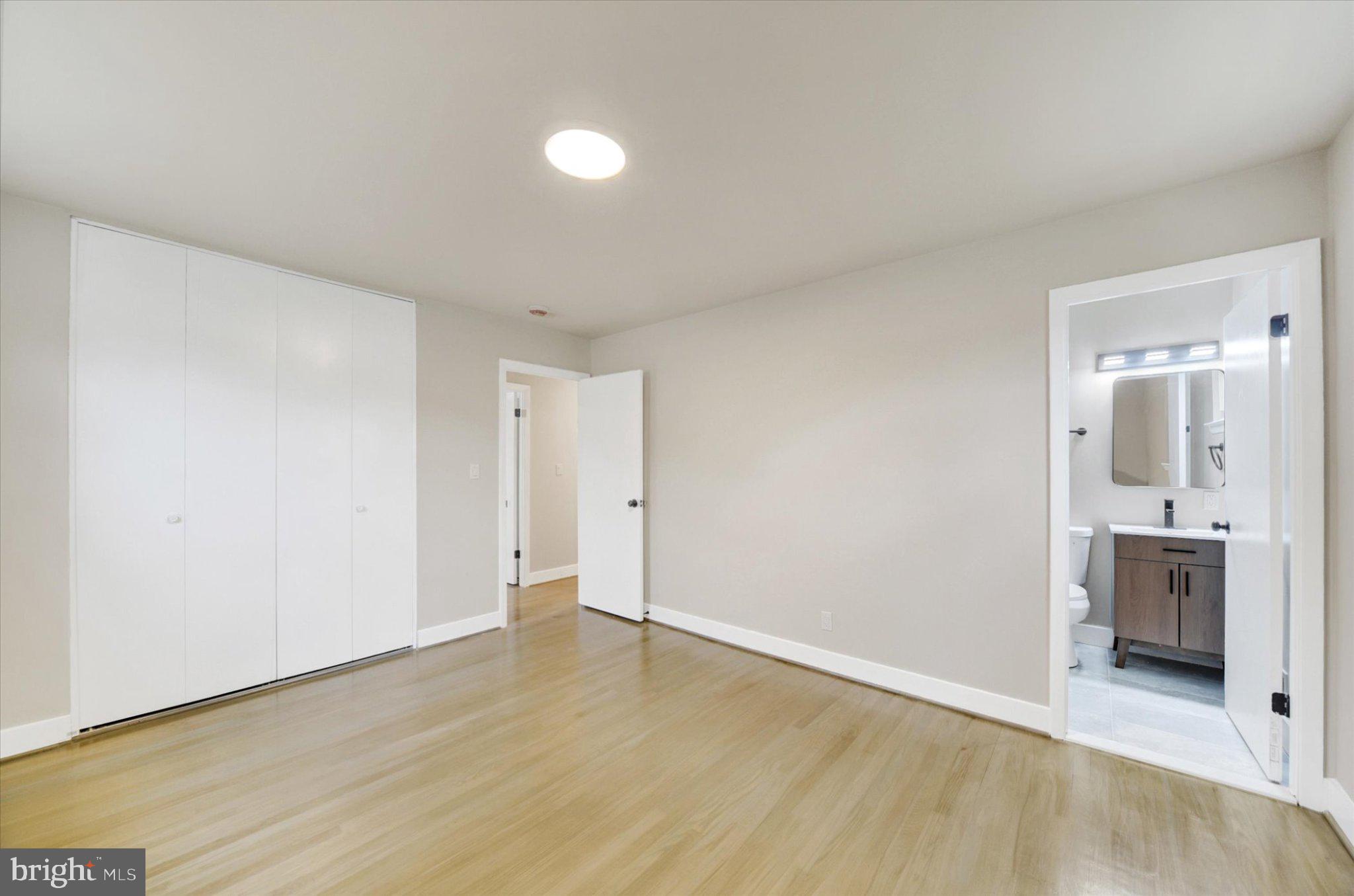 3709 Lamoine Road Randallstown, MD 21133 - Photo 14 of 25 an empty room with wooden floor and bathroom
