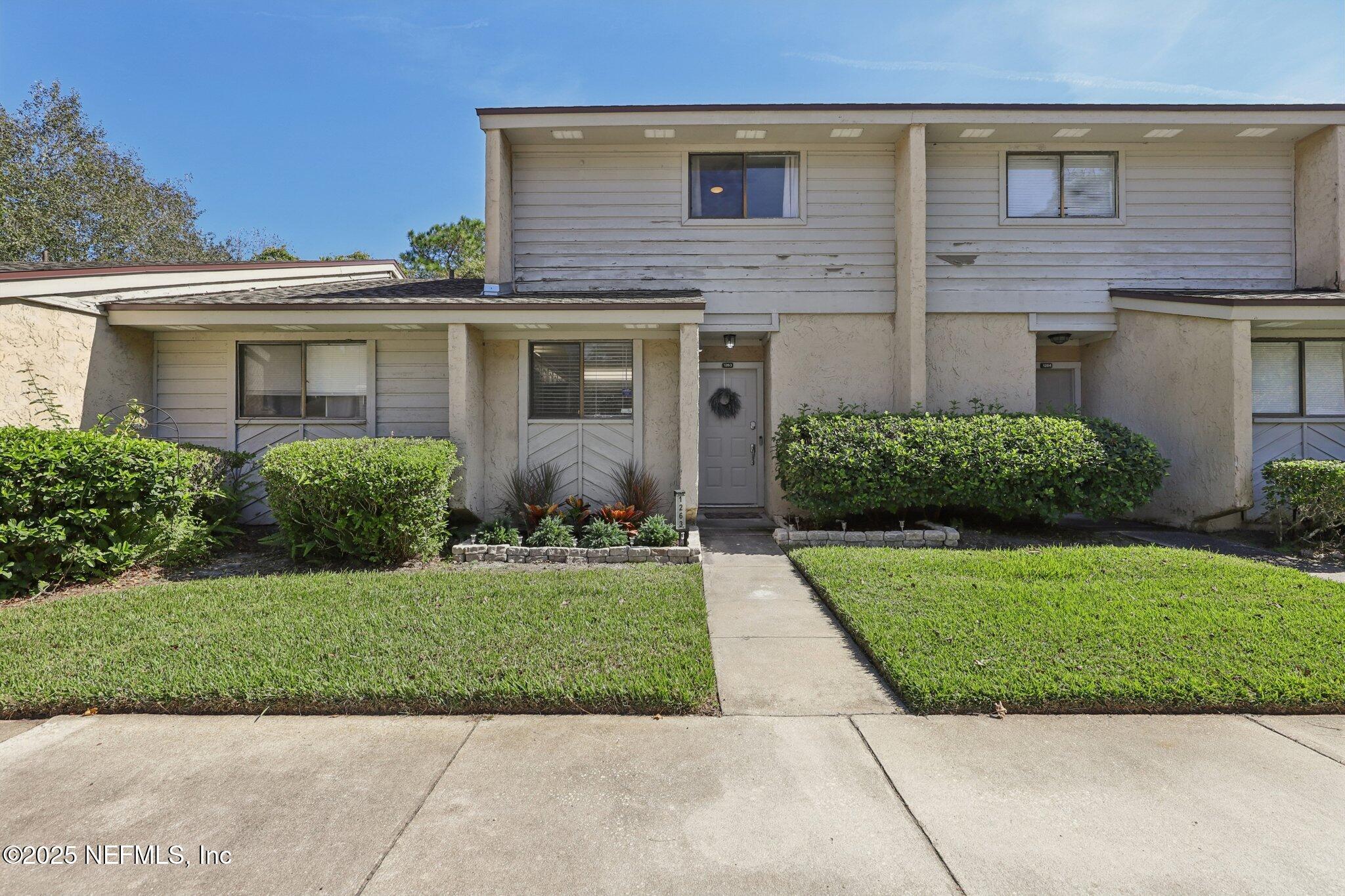 a front view of a house with a garden