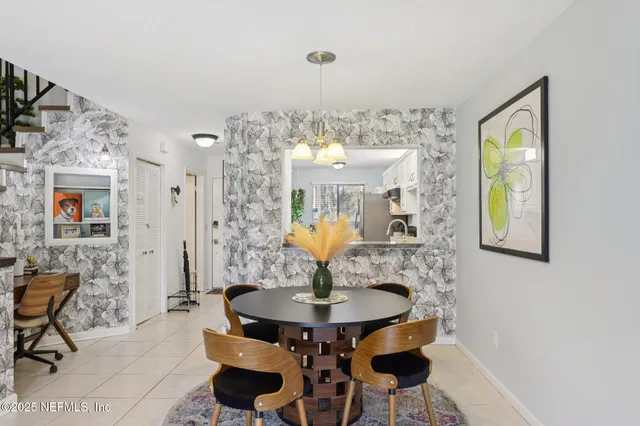 a dining room with furniture and a chandelier