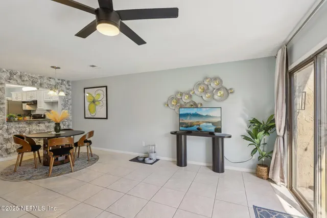 a living room with furniture and a potted plant