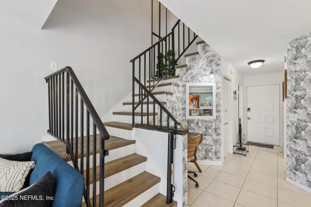 a view of entryway with wooden floor and stairs