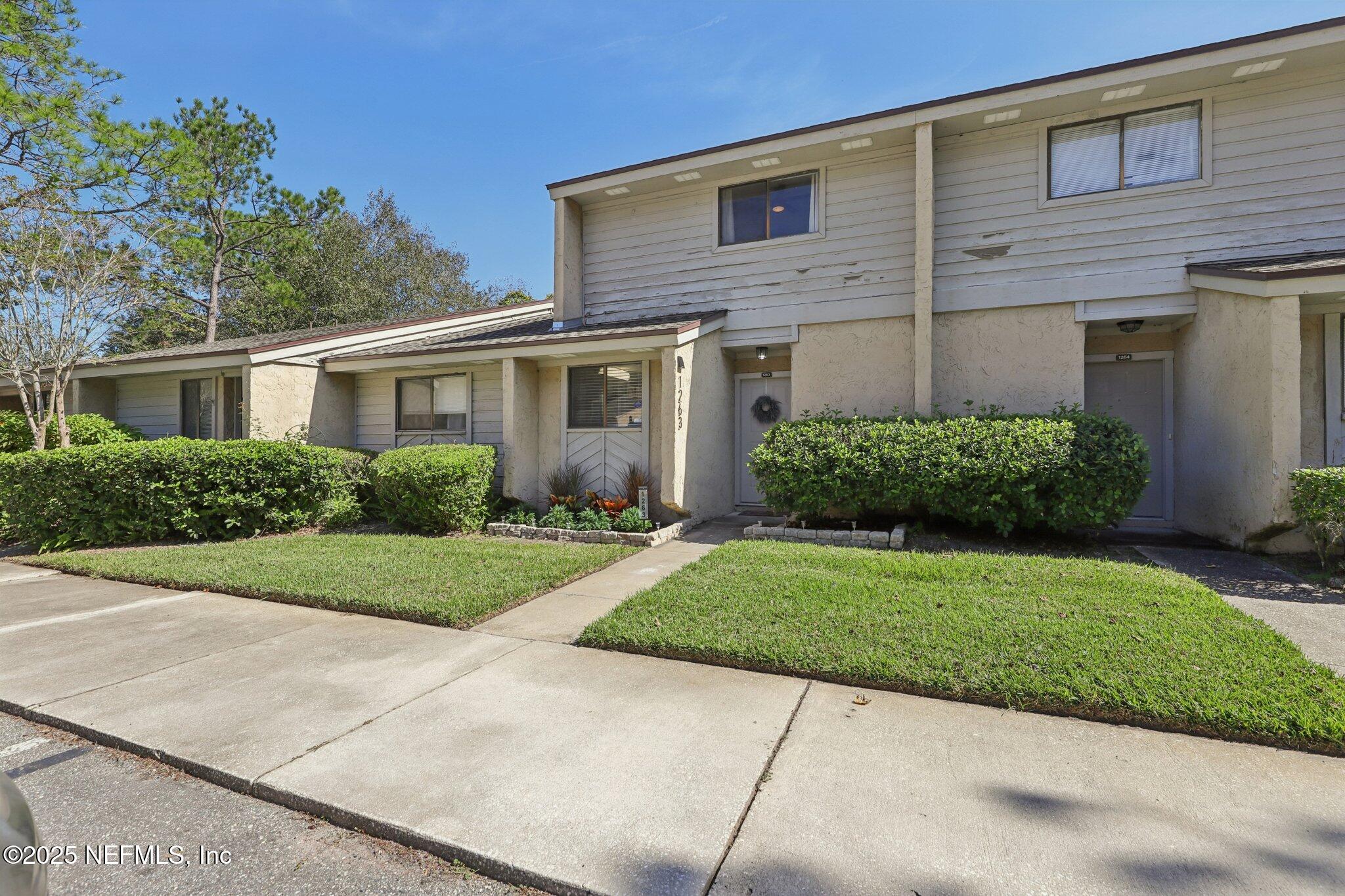3801 Crown Point Road, Unit 1263 Jacksonville, FL 32257 - Photo 2 of 33 a front view of a house with a yard