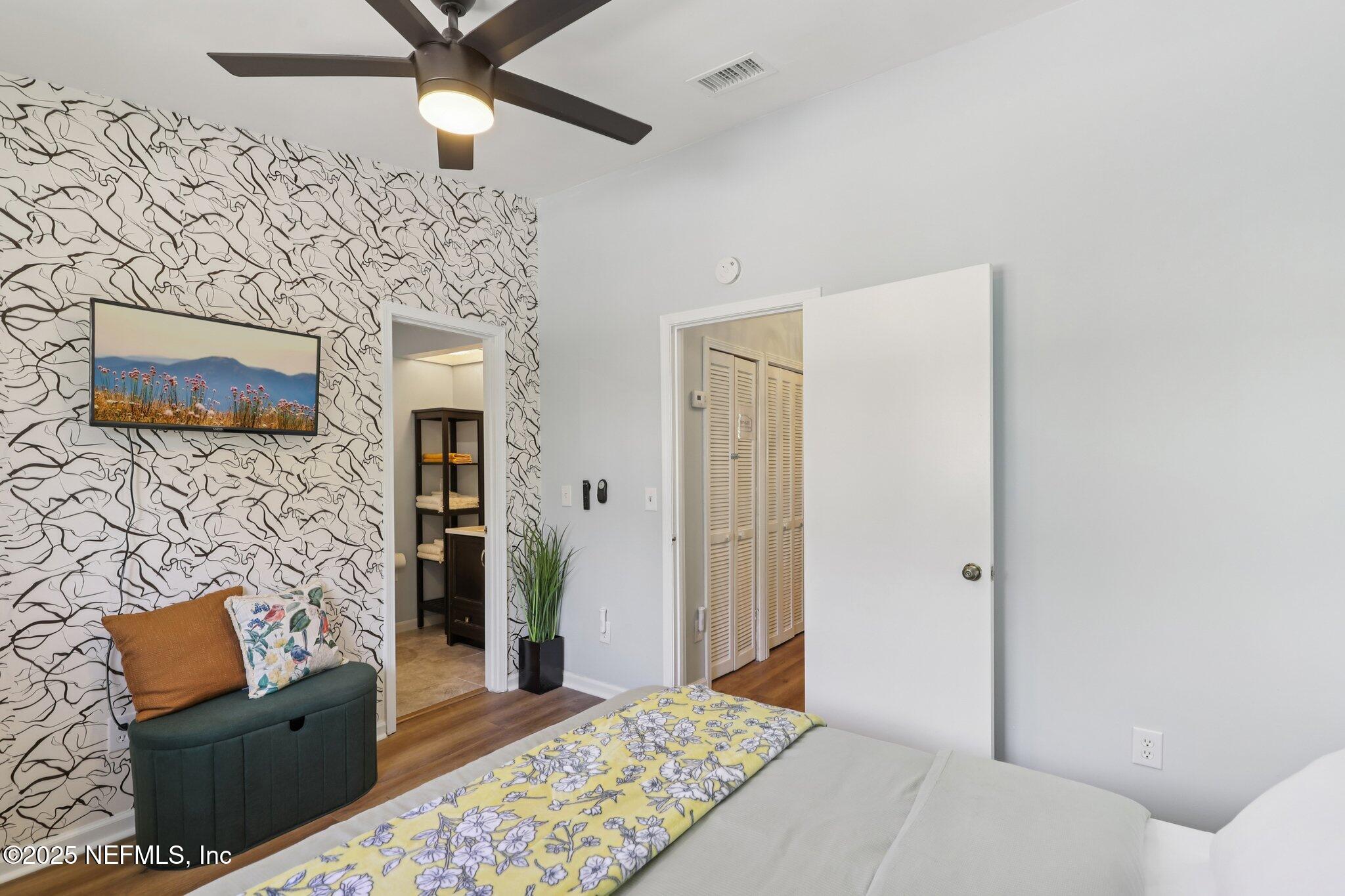 3801 Crown Point Road, Unit 1263 Jacksonville, FL 32257 - Photo 21 of 33 a bedroom with furniture and a fireplace