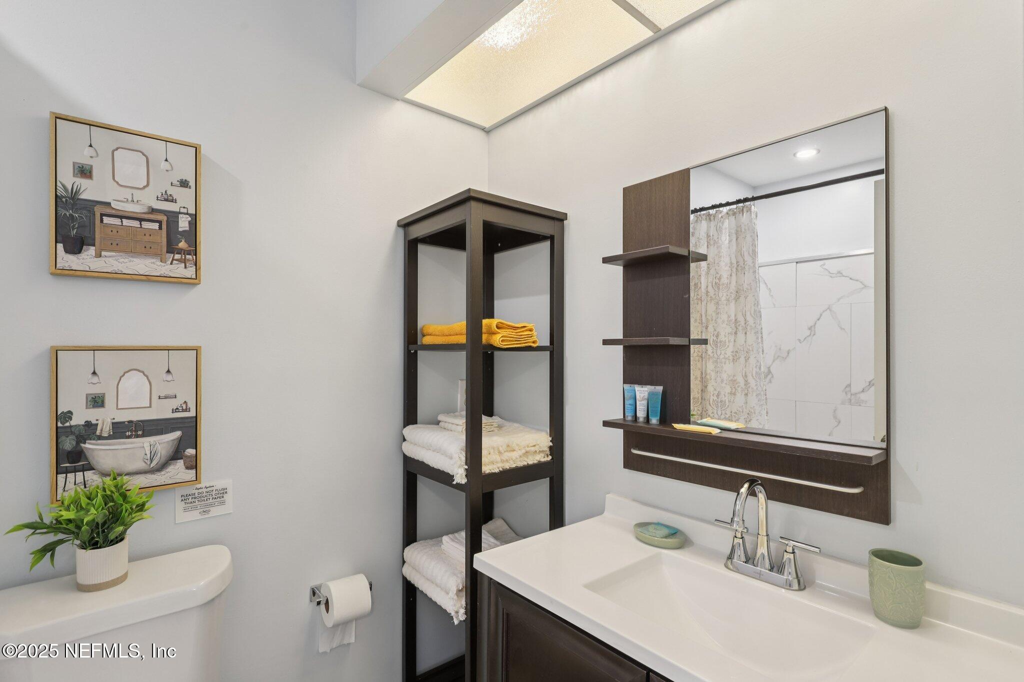 3801 Crown Point Road, Unit 1263 Jacksonville, FL 32257 - Photo 23 of 33 a bathroom with a sink and a mirror