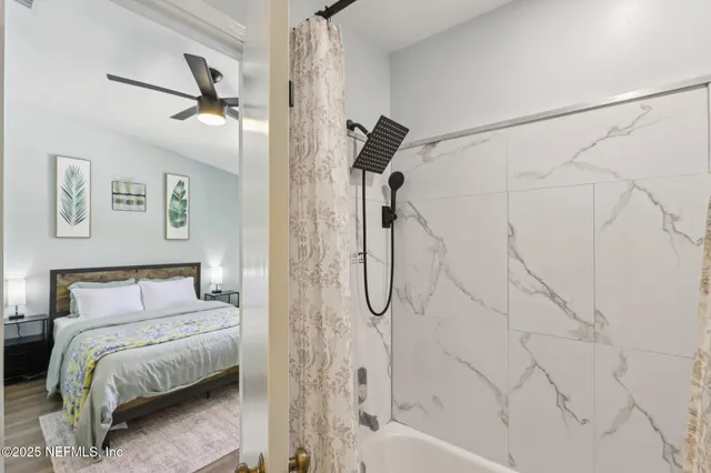 a bathroom with a bathtub and a shower