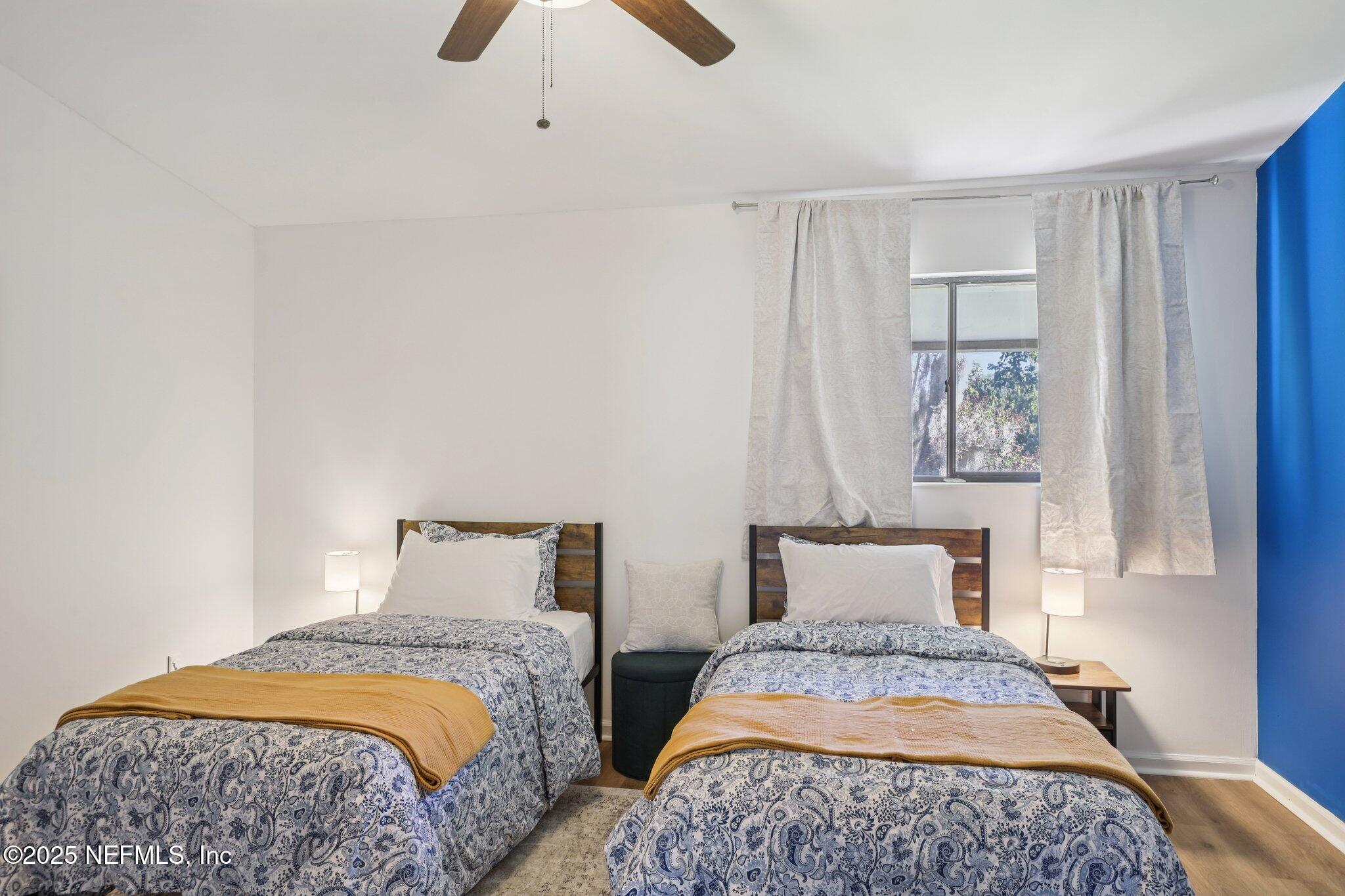 3801 Crown Point Road, Unit 1263 Jacksonville, FL 32257 - Photo 25 of 33 a bedroom with a bed and painting on the wall