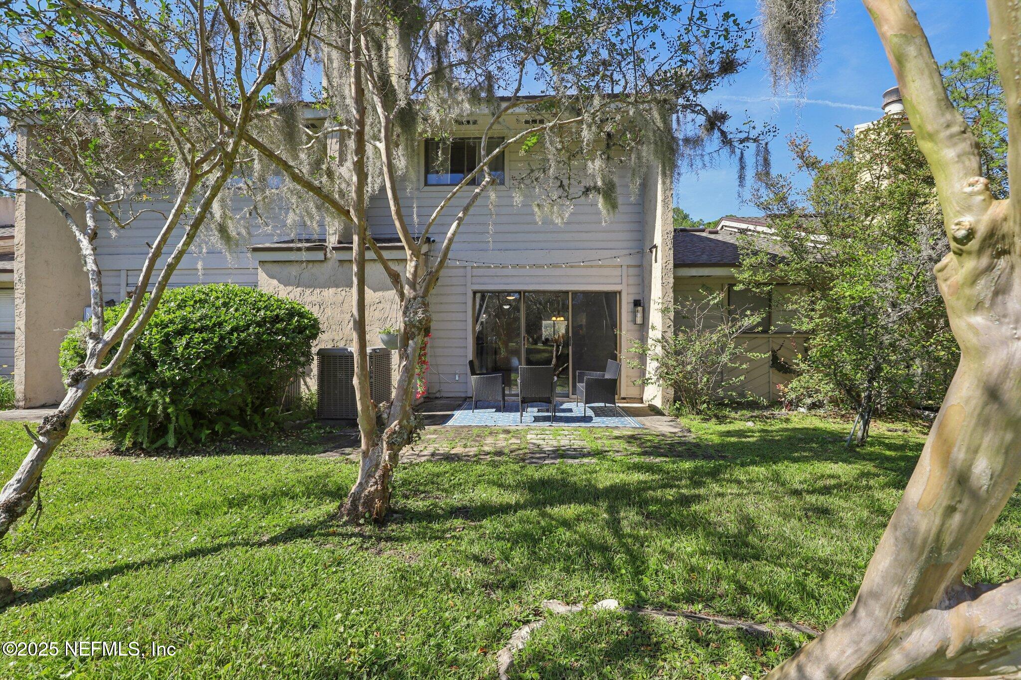 3801 Crown Point Road, Unit 1263 Jacksonville, FL 32257 - Photo 30 of 33 a view of a house with backyard and a tree