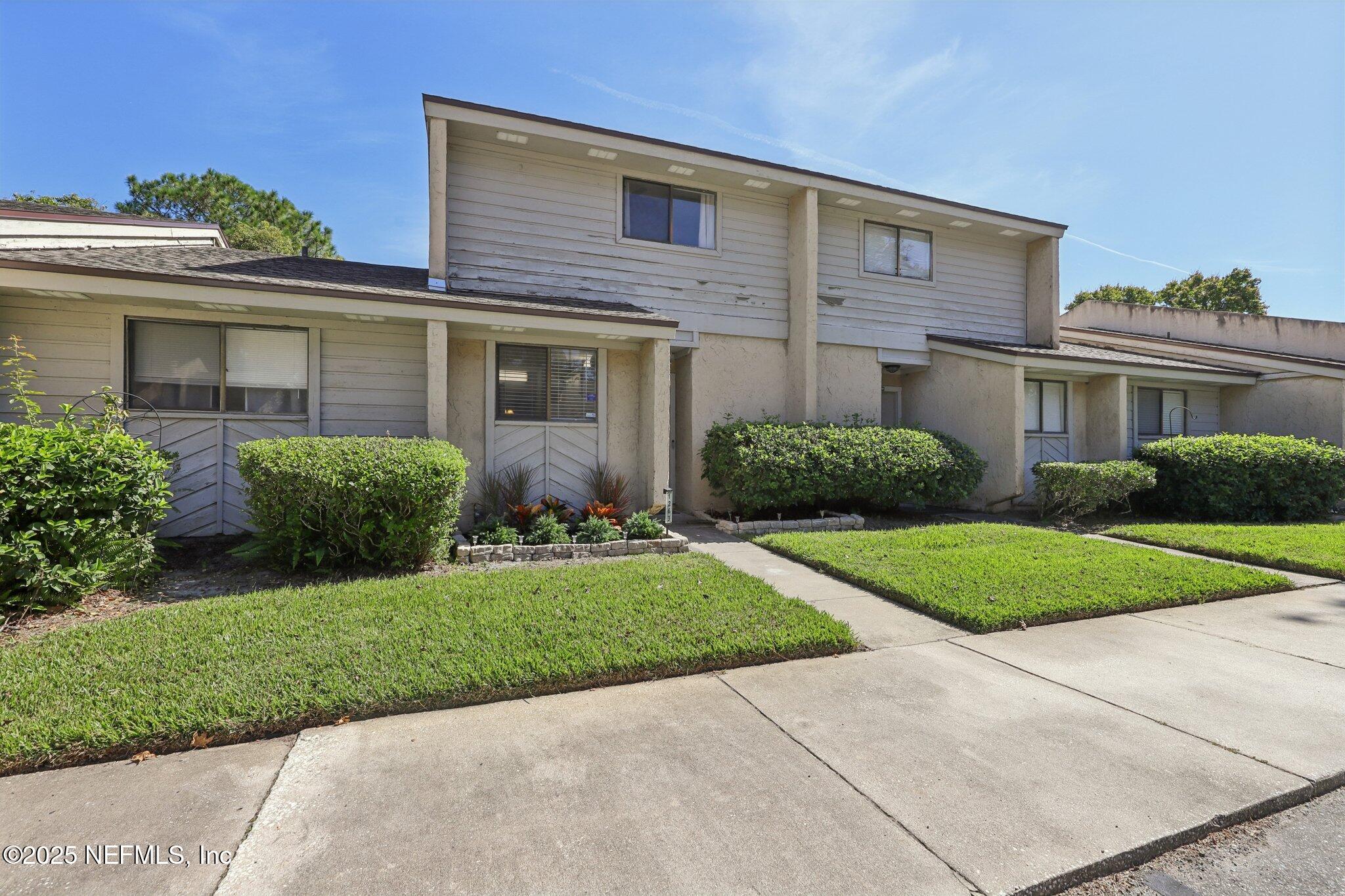 3801 Crown Point Road, Unit 1263 Jacksonville, FL 32257 - Photo 3 of 33 a front view of a house with a yard