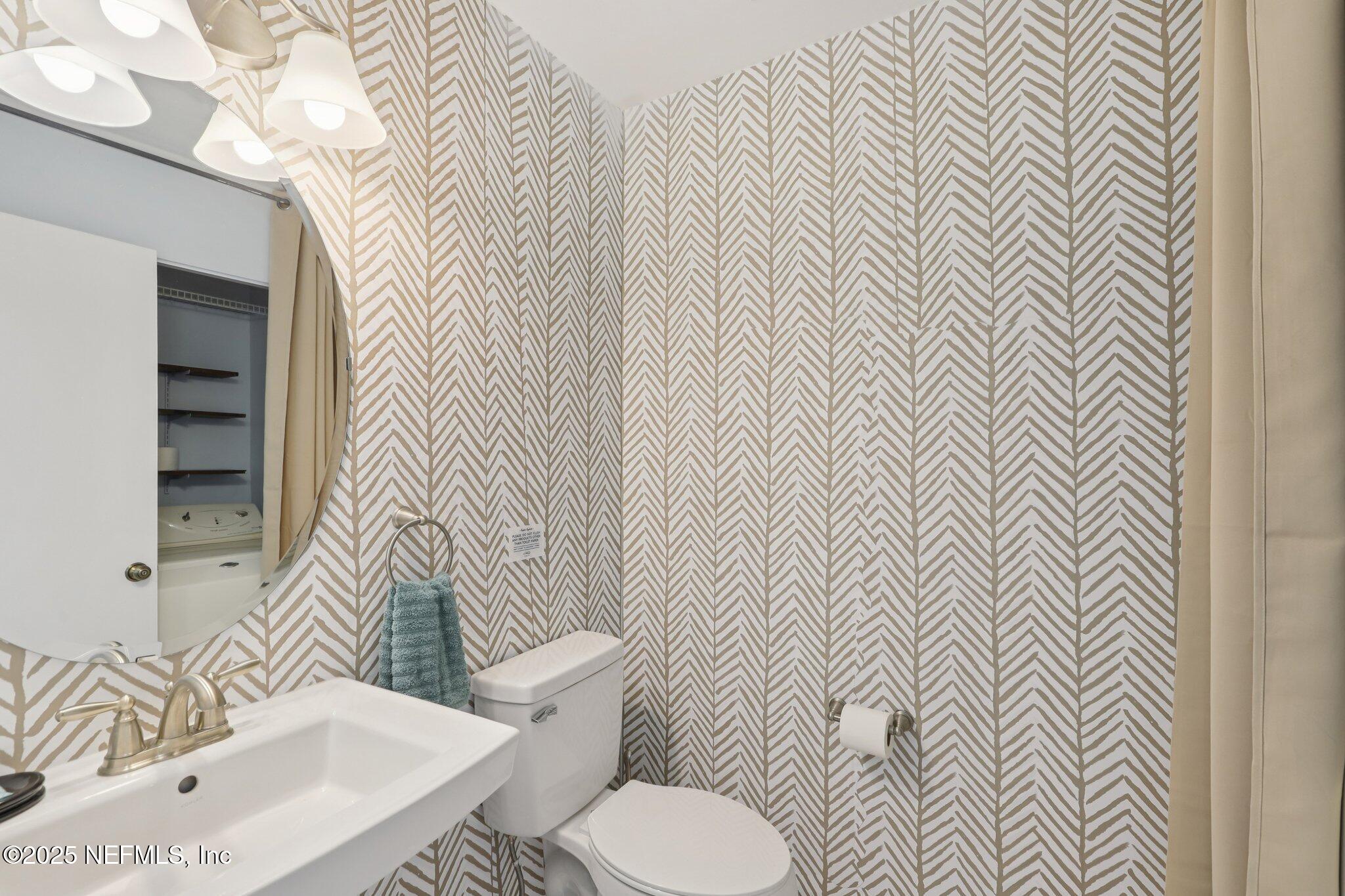 3801 Crown Point Road, Unit 1263 Jacksonville, FL 32257 - Photo 6 of 33 a white toilet sitting next to a bathroom sink